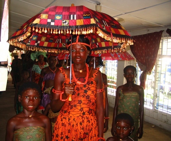 A Bride under a Decorated Umbrella with Her Bridemaids