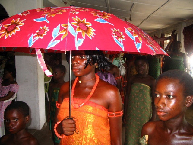 A Bride under a Colourful Umbrella with Her Bridemaids